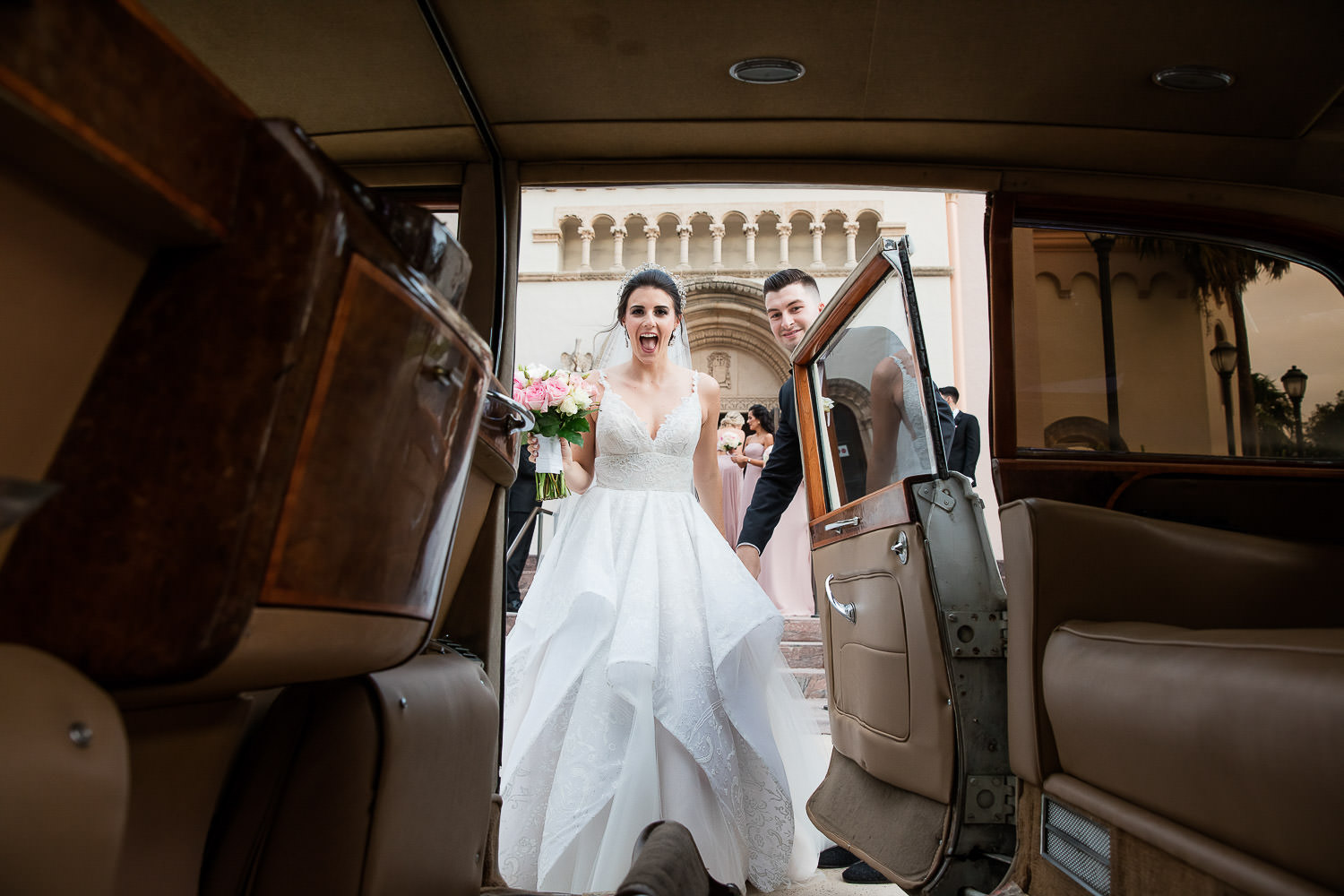Bride gets into a classic Rolls Royce on their way to their wedding at the Mandarin Oriental.
