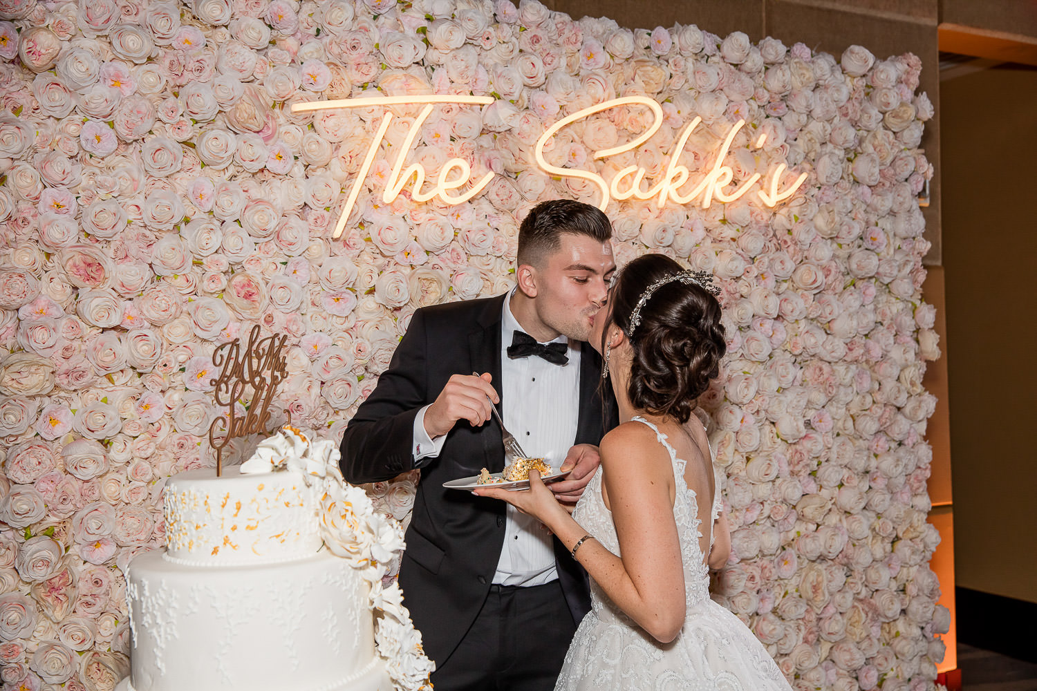 Bride and groom kissing during cake cutting at the Mandarin Oriental.