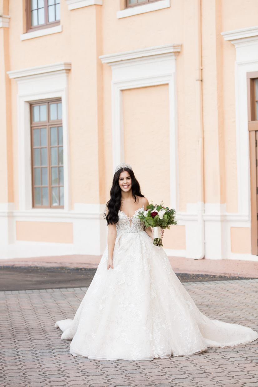 Bride walks down the front stairs in a ballgown on her way to her wedding ceremony at the Biltmore Hotel.