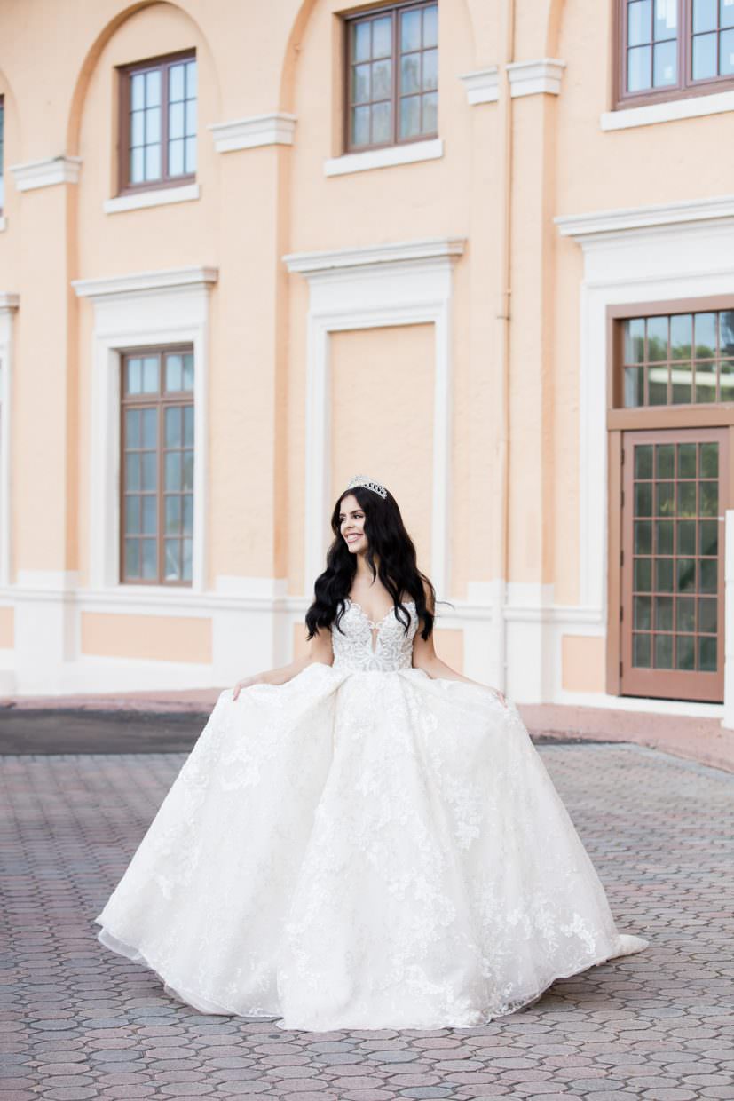 Bride walks down the front stairs in a ballgown on her way to her wedding ceremony at the Biltmore Hotel.