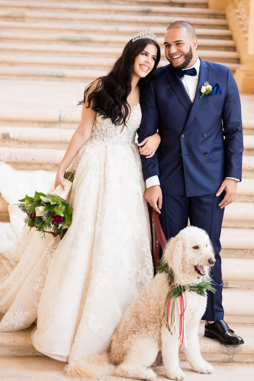 A couple poses with their dog for a portrait at the Biltmore Hotel in Coral Gables.