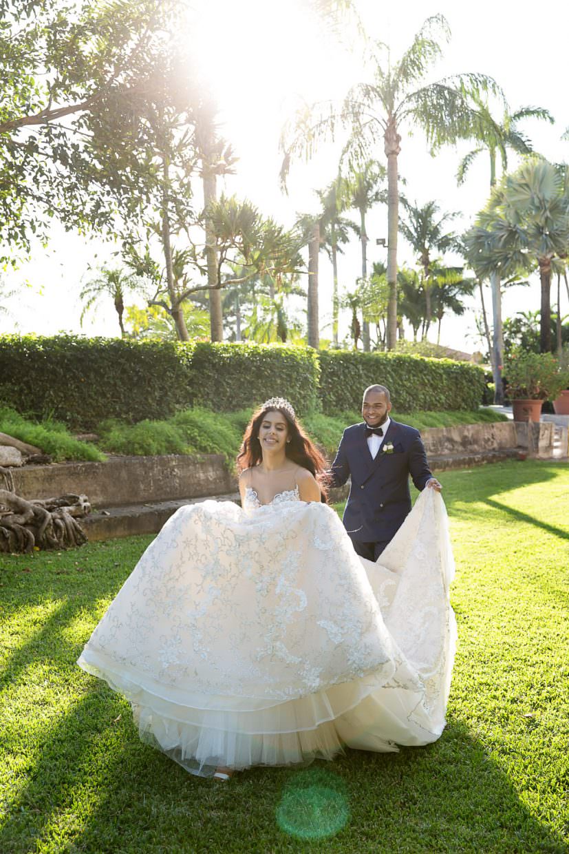 Bride and groom posing for a photo in courtyard at the Biltmore Hotel on their wedding day.