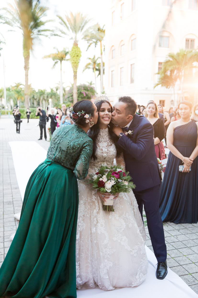 Bride walks down the aisle during a wedding at the Biltmore Hotel in Miami.