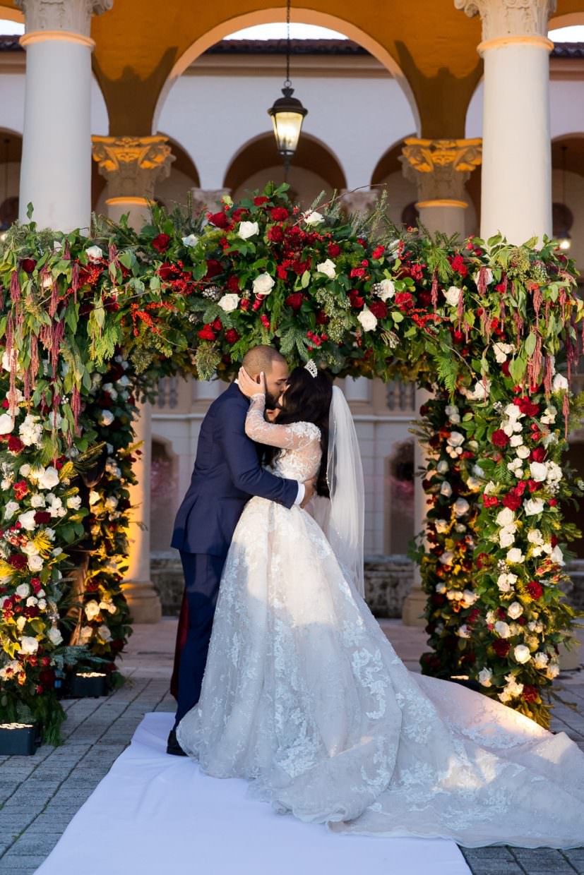 Bride and groom kissing at their wedding at the Biltmore Hotel in Miami.