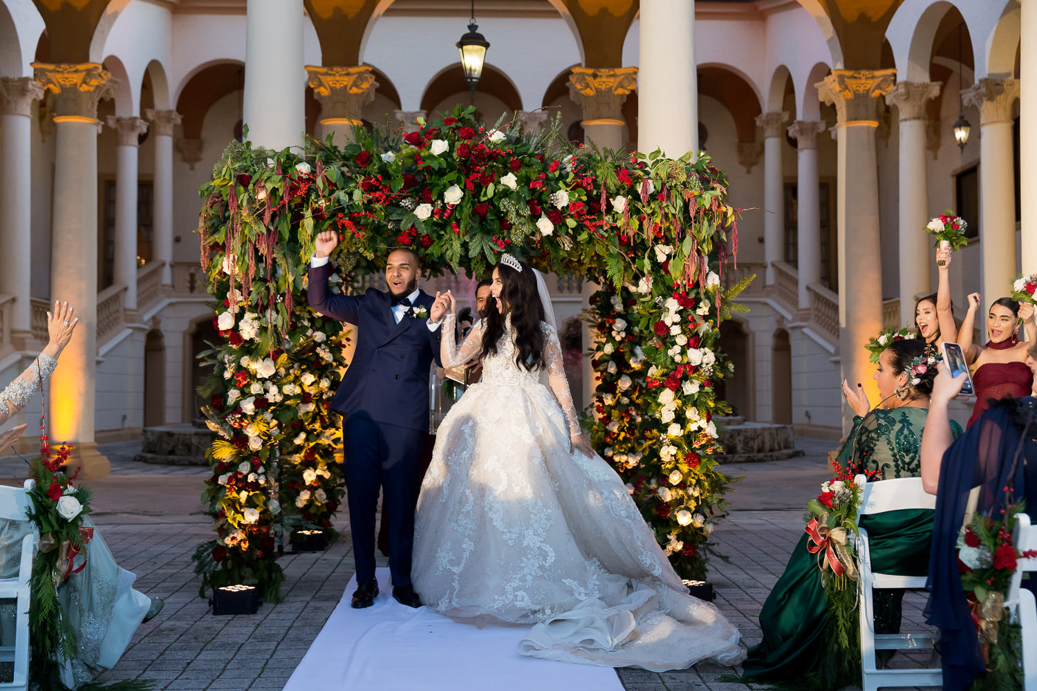 Bride and groom walking down the aisle during their wedding at the Biltmore hotel in Miami.