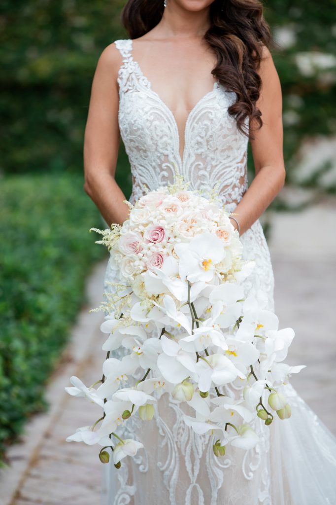 detail photo showing brides bouquet and wedding dress