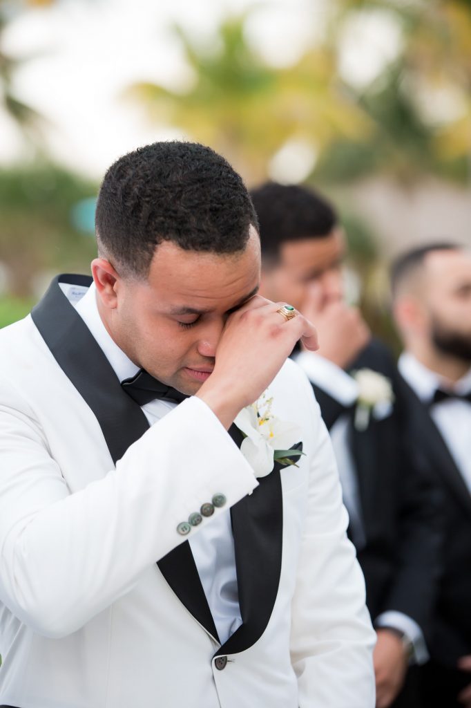 groom moved to tears as bride makes her entrance for the wedding ceremony