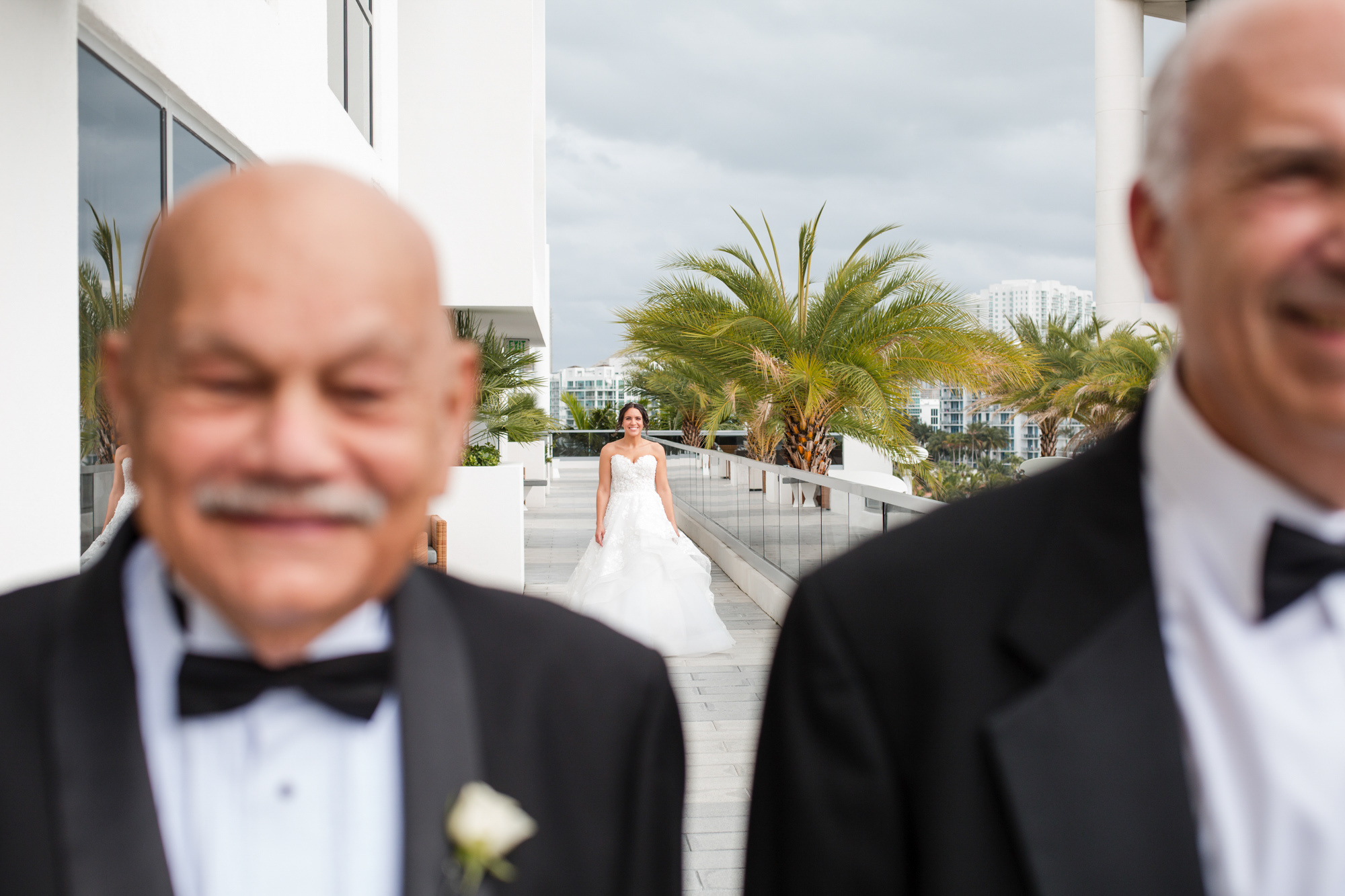 bride walks to meet her dad and grandfather during the first look during their Beth Torah Benny Rok Temple Wedding Photography