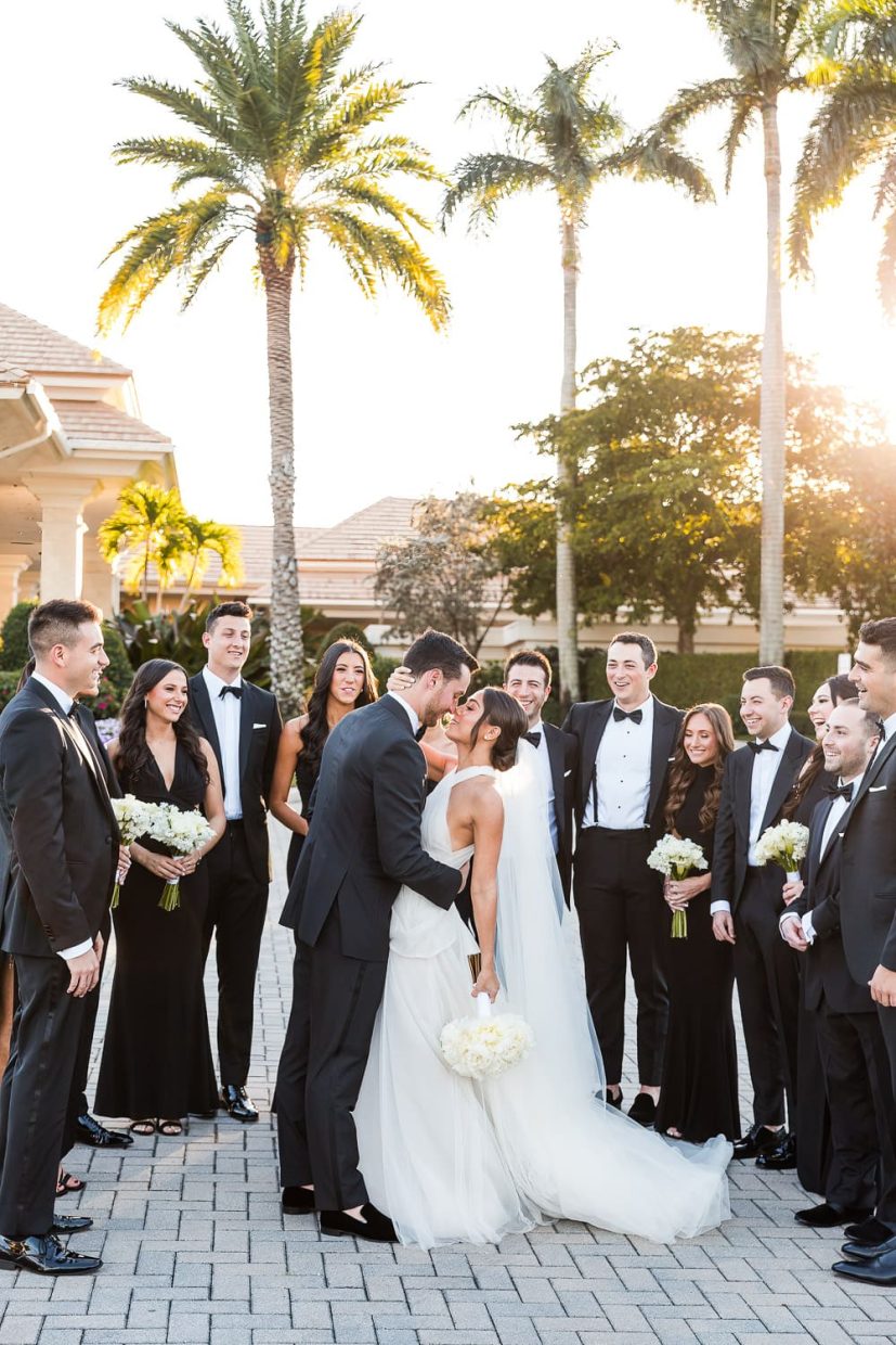 Bride and groom kiss during their wedding at sunset at the Polo Club in Boca Raton.