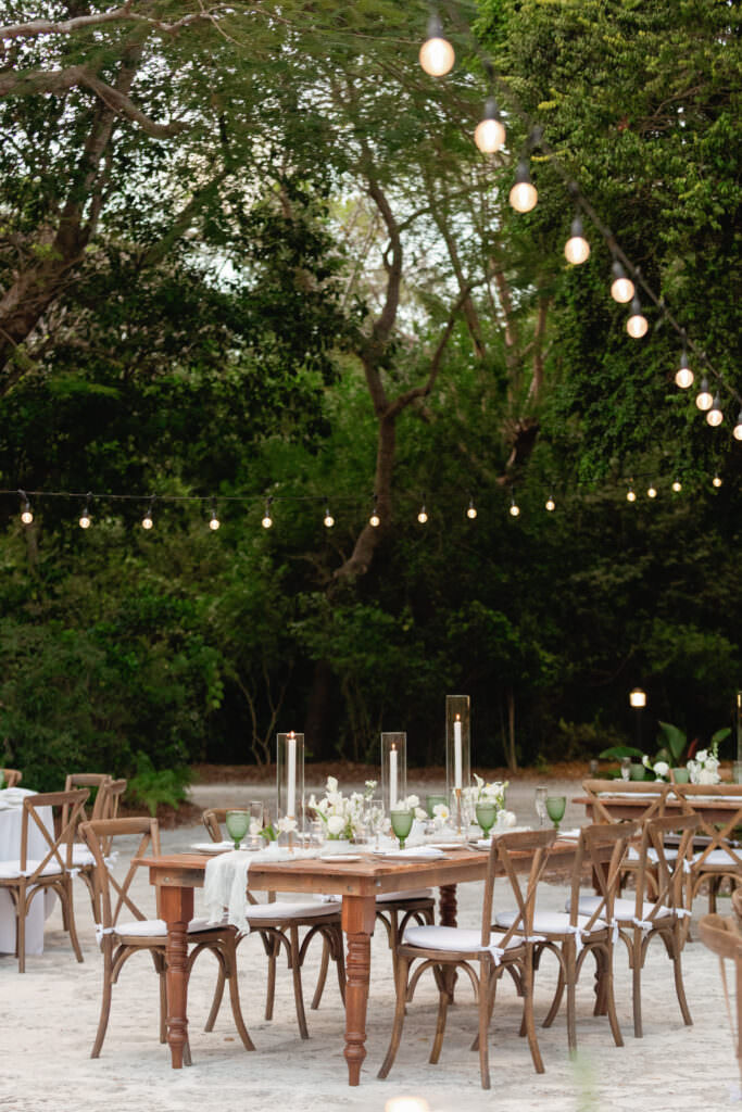 Wedding reception set under the trees at Deering Estate