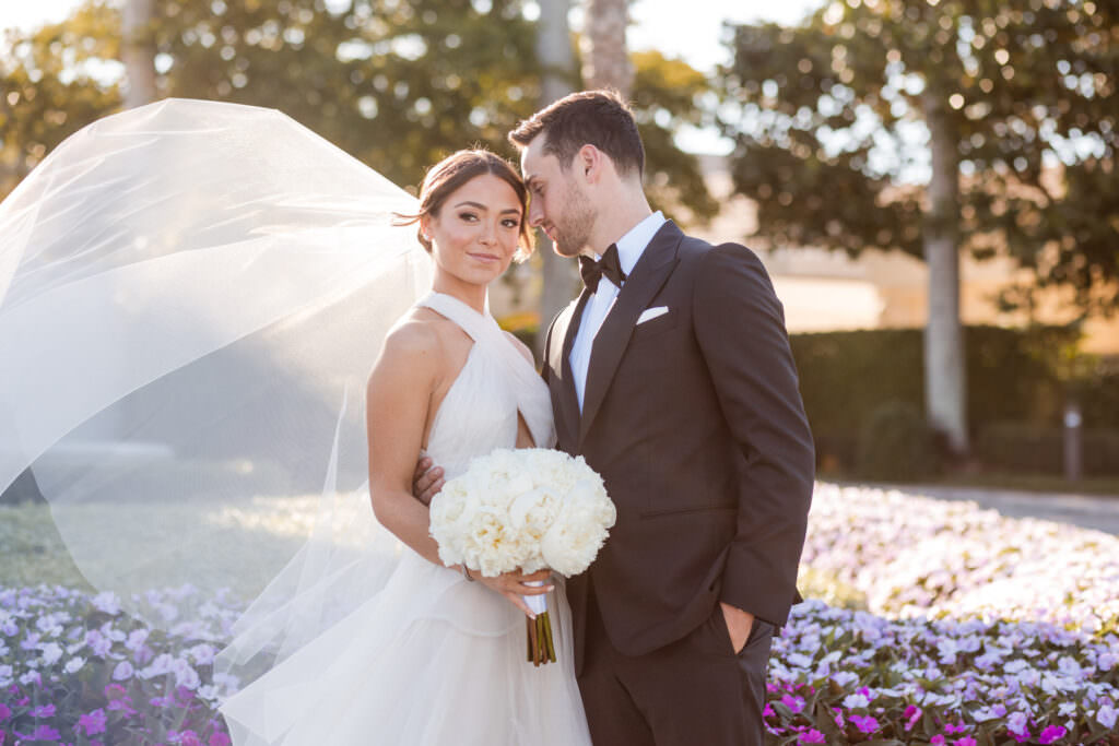 Groom smiling at bride during their wedding portraits in Boca Raton