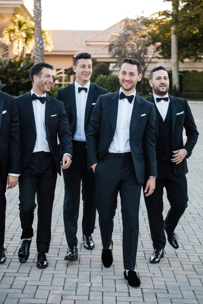 Bridesmaids and groomsmen candid moment before ceremony at The Polo Club