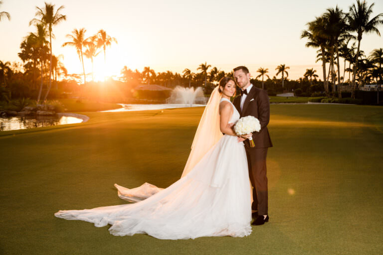 Timeless wedding portrait of bride and groom with glowing sunset light behind them