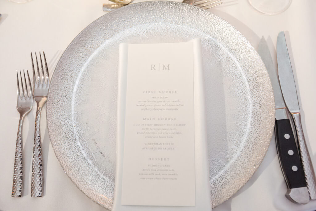 Refined tabletop styling with menus and candlelight at Boca Raton wedding