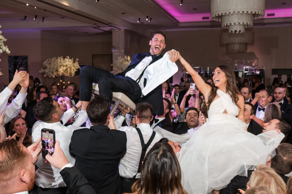 Guests dancing and celebrating during the energetic hora at the Polo Club wedding