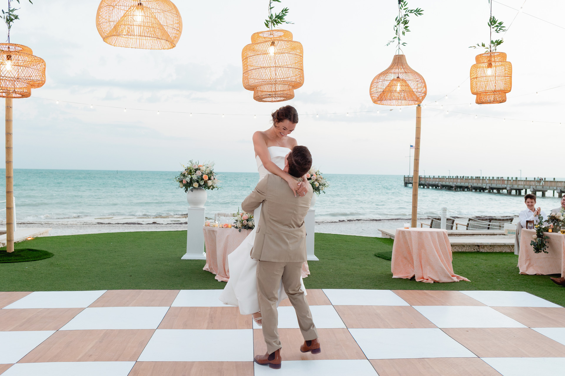 Bride and groom share a first dance as the sunsets by the ocean at Casa Marina in Key West.