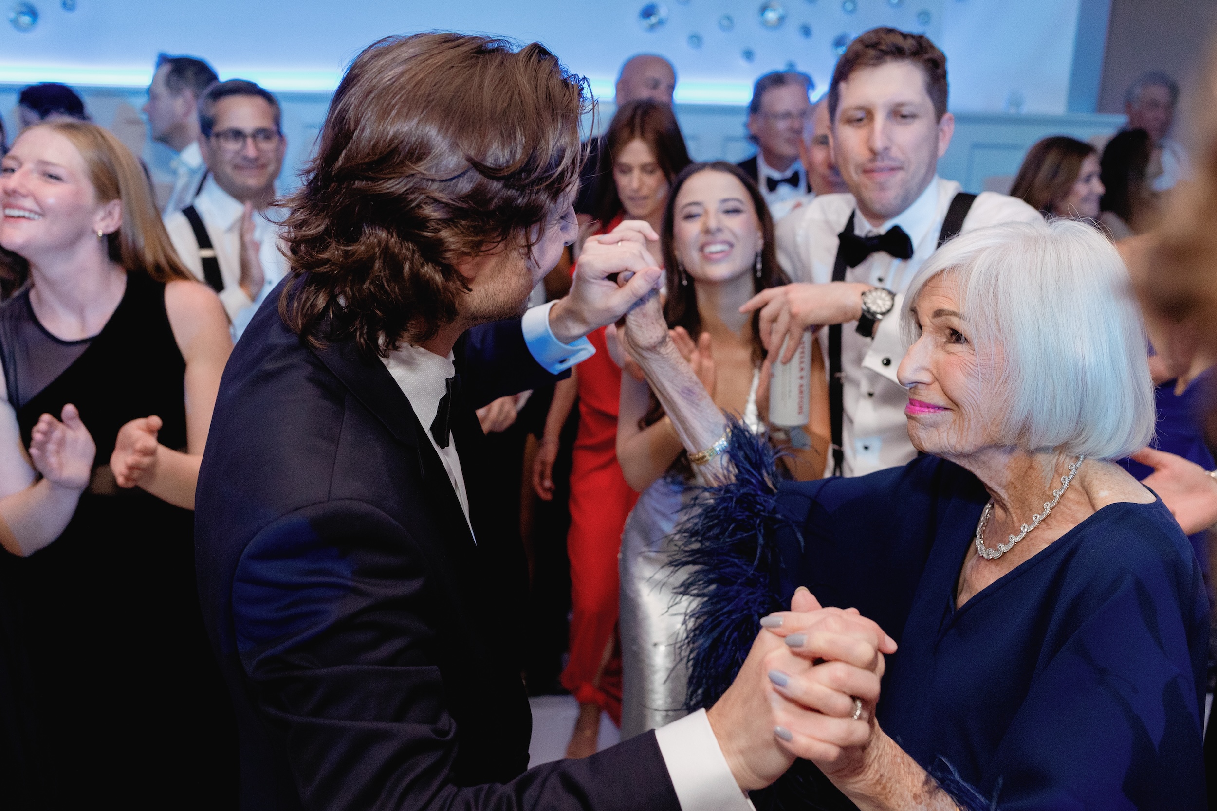 Groom Embracing Grandmother on Dance Floor at Addison Reserve Country Club Wedding