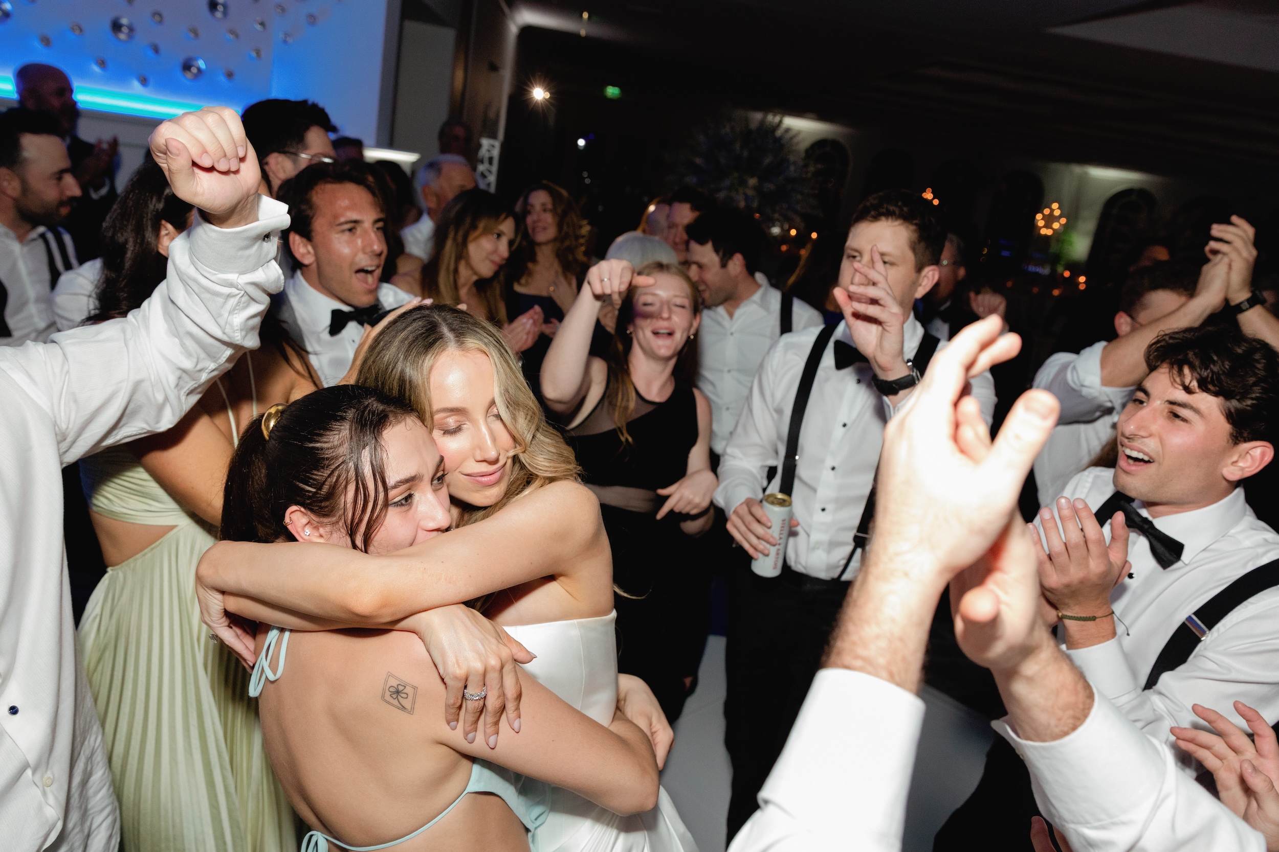 Bride and Friend Embrace on Dance Floor of Addison Reserve Country Club Wedding
