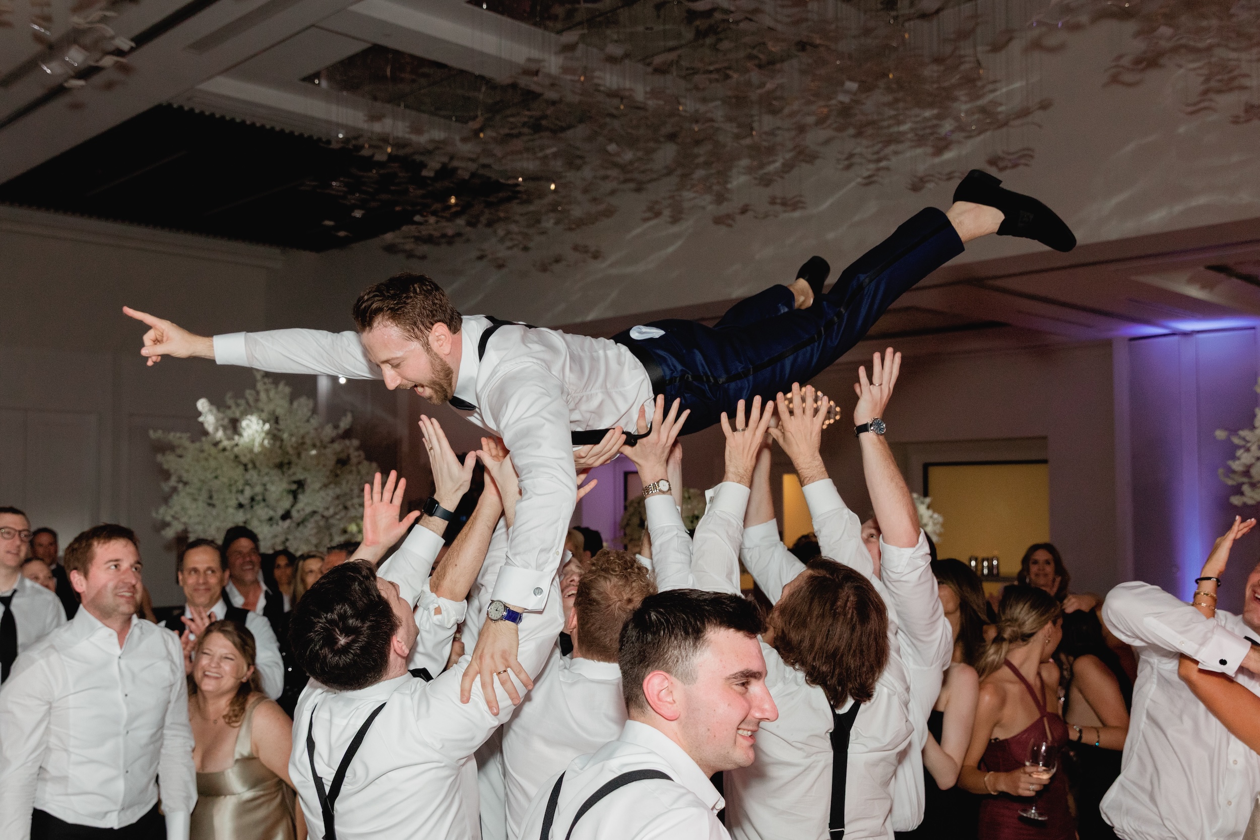 Groom on Dance Floor Crowd Surfing with Groomsmen