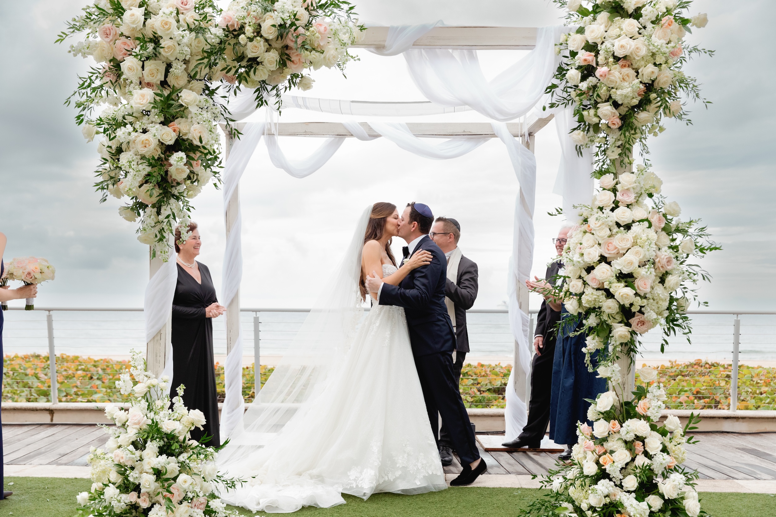Bride and Groom Kiss Under Chuppah at Marriott Harbor Beach Fort Lauderdale Wedding
