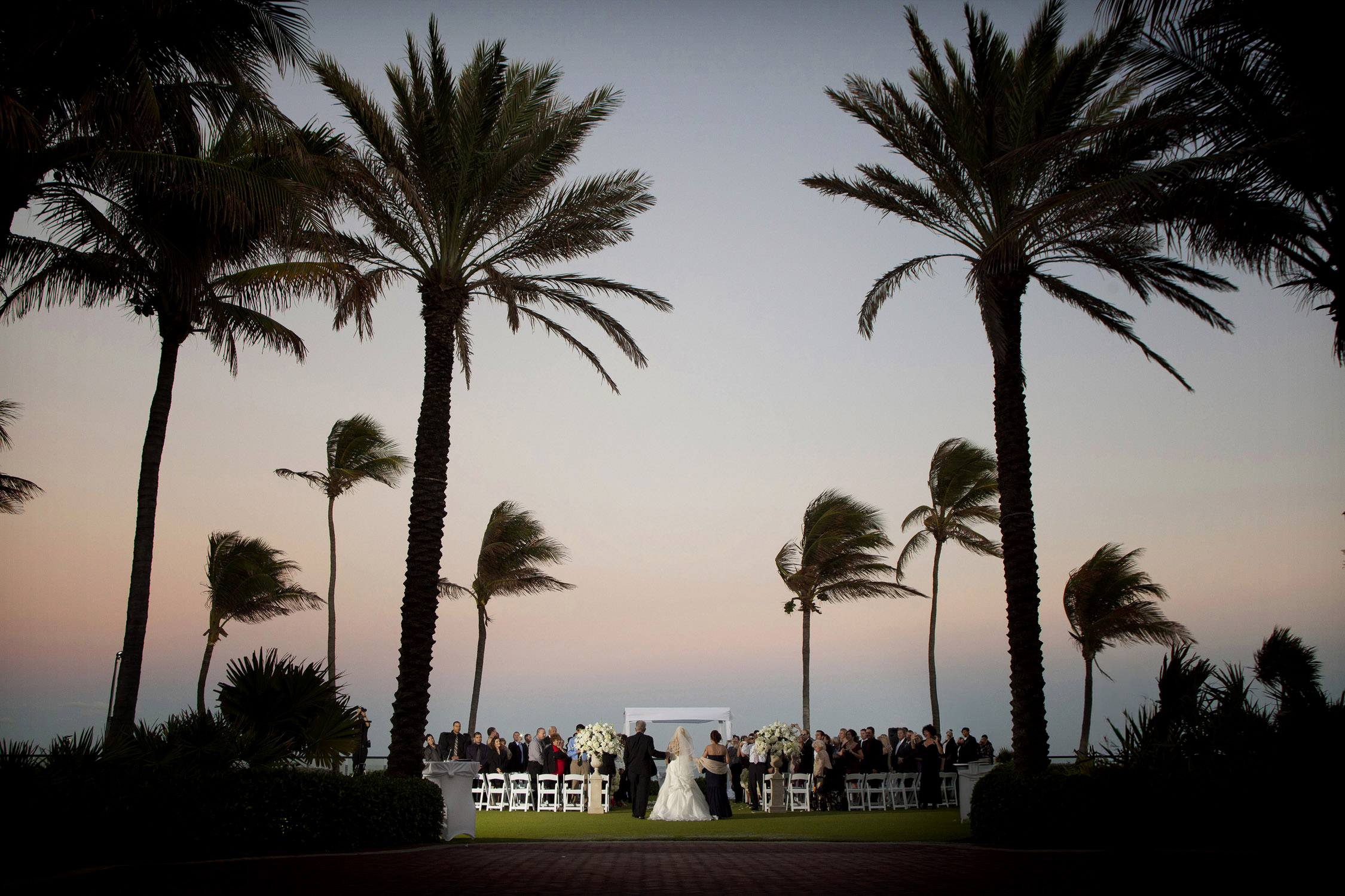 Outdoor Sunset Wedding Ceremony on Lawn at Breakers Palm Beach