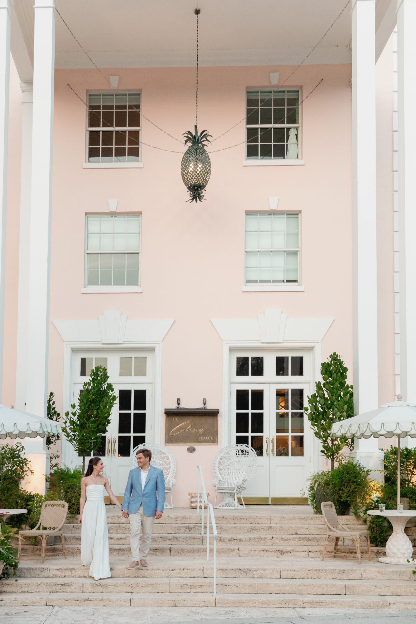 Bride and Groom Holding Hands Walking Down Stairs at The Colony Palm Beach
