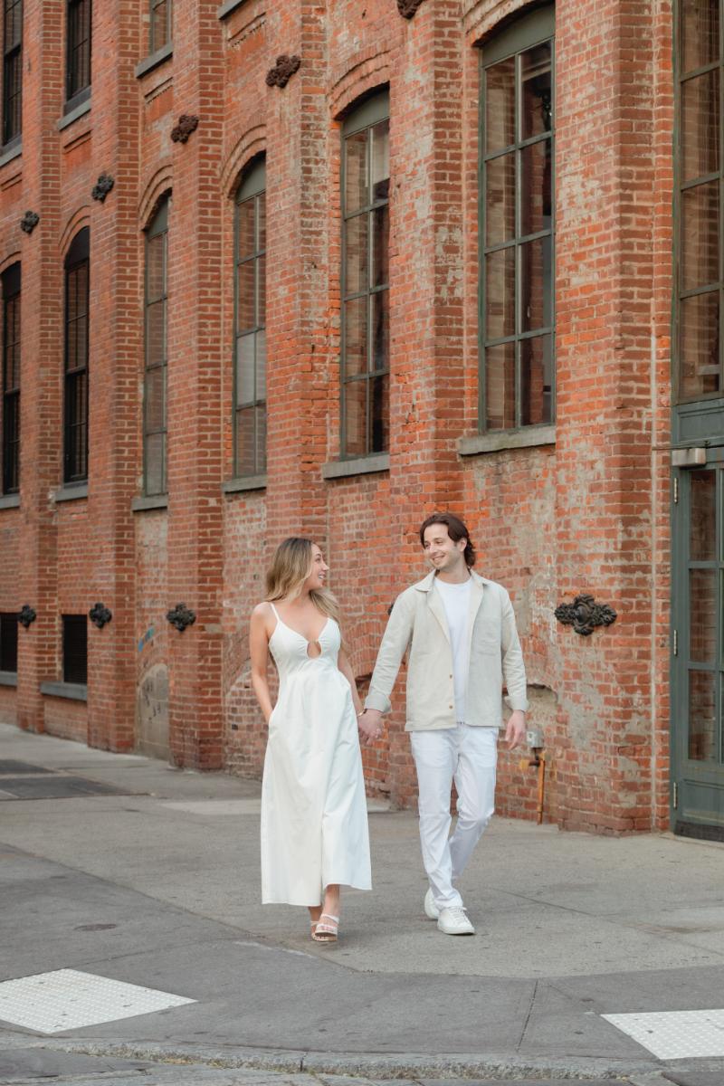 Engaged Couple Holds Hands, Walks Through Streets of Dumbo Brooklyn