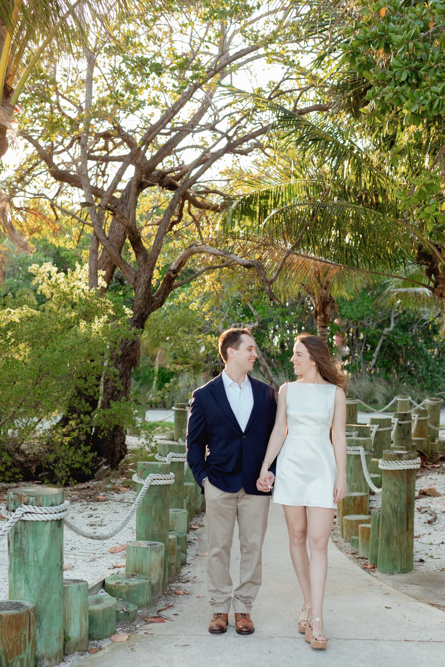 Engaged Couple Hold Hands, Walk Through Matheson Hammock Park
