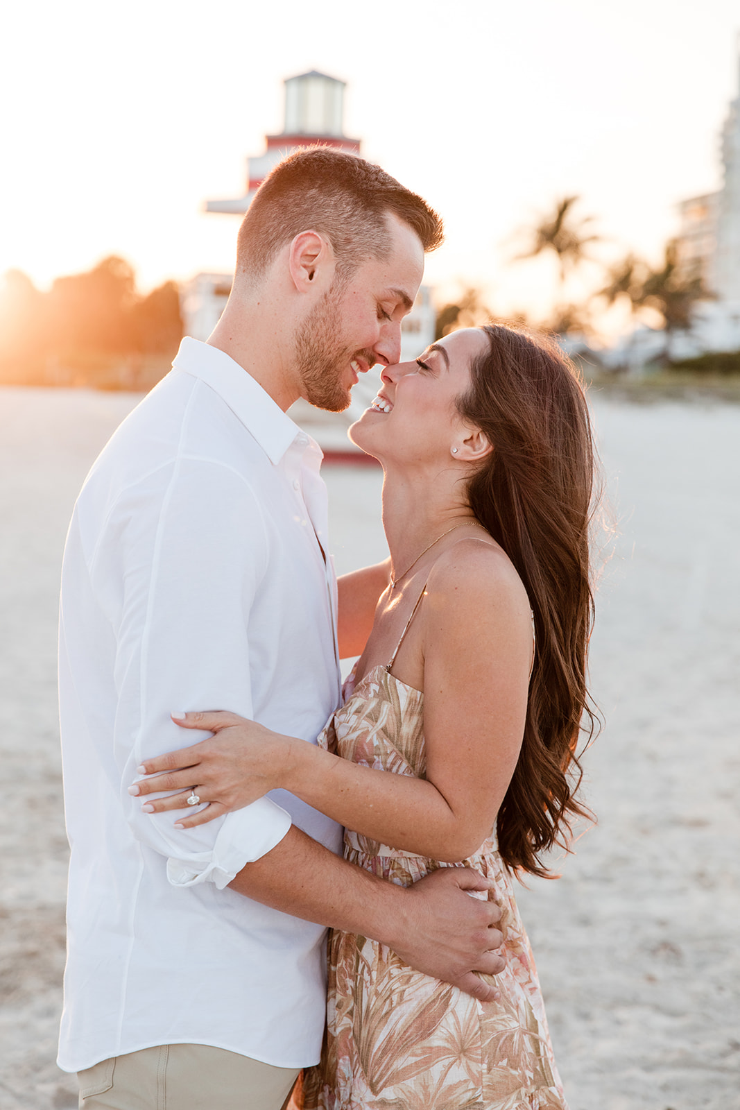 Couple Embrace, Lean in for Kiss During Engagement Portrait Session Miami Beach