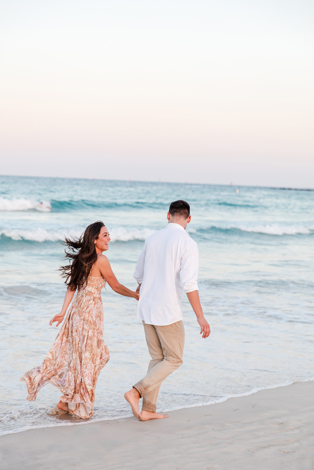 Couple Runs Through Shore of Miami Beach During Engagement Portraits