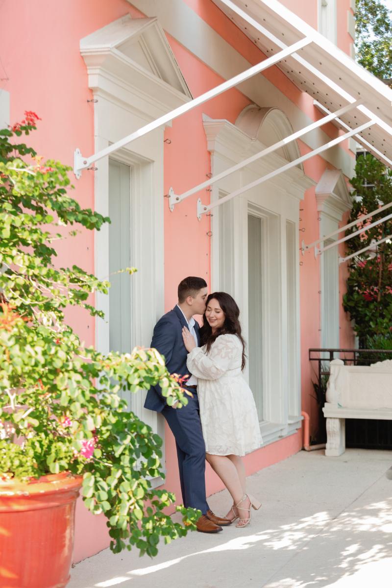 Couple Leans Against Colorful Wall in Naples FL for Engagement Photography
