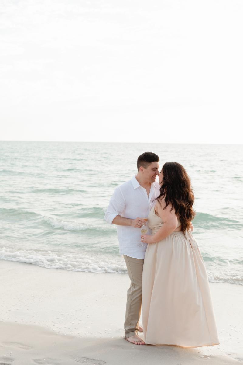 Engaged Couple Embrace, Toast one Another During Engagement Photoshoot Naples, FL