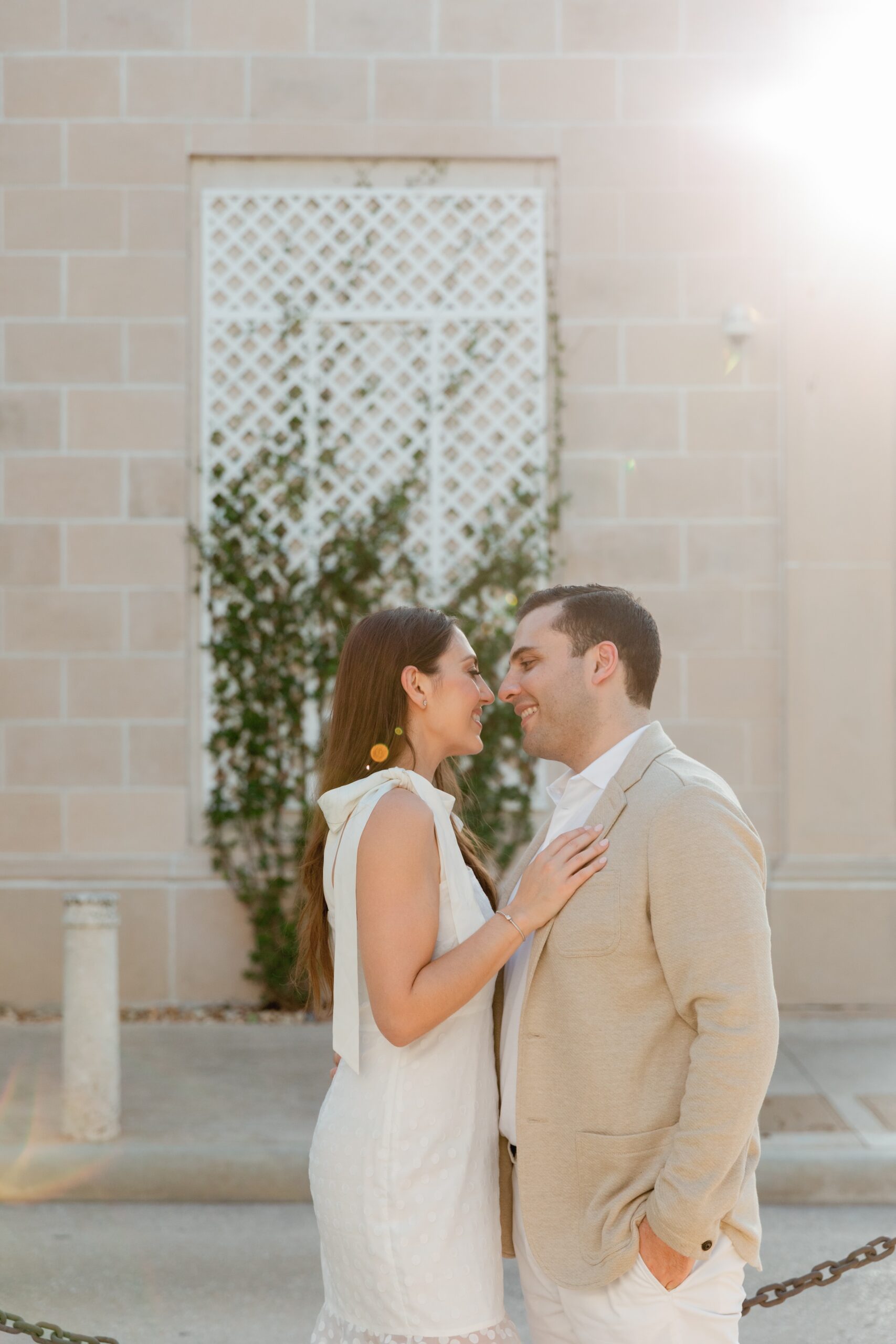 Engaged Couple Lean in for Kiss During Engagement Photoshoot Palm Beach