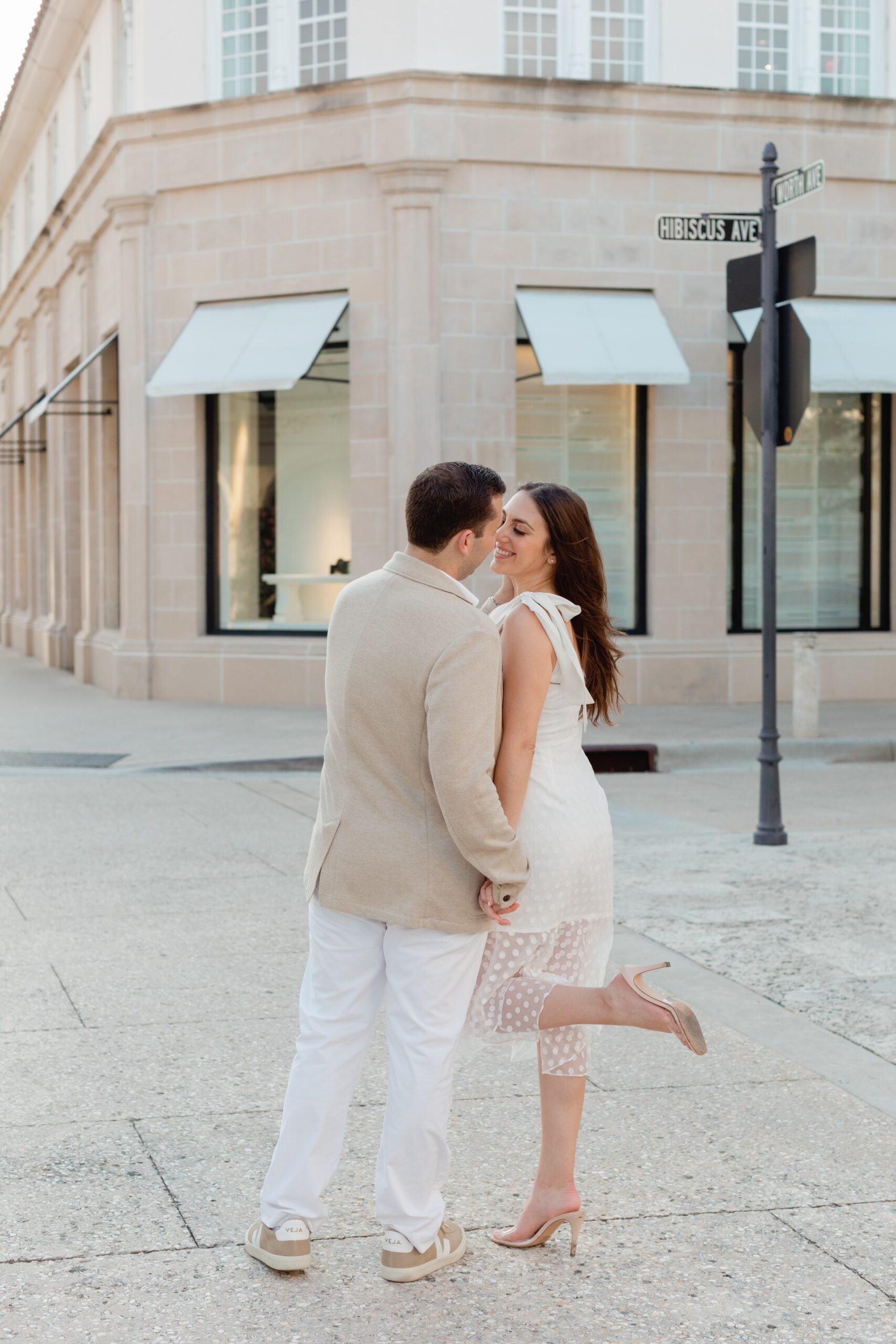 Couple Stops for Kiss on Worth Avenue in Palm Beach During Engagement Photoshoot